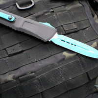 Microtech Combat Troodon Gen III OTF Knife- Double Edge- Black Handle- Turquoise Plain Edge Blade 1142-1 TQSK Gen III 2024