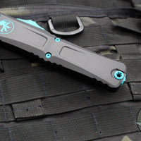 Microtech Combat Troodon Gen III OTF Knife- Double Edge- Black Handle- Turquoise Plain Edge Blade 1142-1 TQSK Gen III 2024