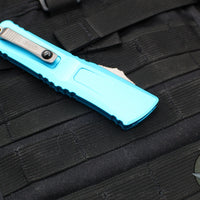 Microtech Combat Troodon Gen III OTF Knife- Double Edge- Turquoise Handle- Stonewash Part Serrated Blade 1142-11 TQ Gen III