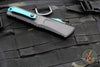 Microtech Combat Troodon Gen III OTF Knife- Double Edge- Black Handle- Turquoise Full Serrated Edge Blade 1142-3 TQSK Gen III 2024