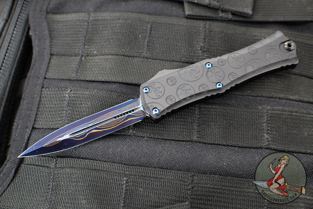 Microtech Hera II OTF Knife- MINI- Double Edge- Black Deep Logo Burst Handle- Blued Baker Forge Coppermai Damascus Blade- Blue HW 1702M-16 MS3