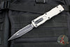 Microtech Dirac Delta OTF Knife- Double Edge- Titanium Gray Handle- Black Full Serrated Blade and Black HW 227-3 TG