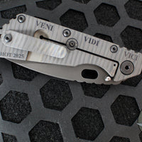 Strider Knives SMF- Drop Point- Shot Show 2025- Veni Vidi Vici- Black Slotted Aluminum And Flamed Ti- Black Magnacut Blade