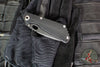 Mick Strider SnG Folder- Spearpoint- Contoured Black G-10/ Flamed Titanium- Black 20CV Steel Blade