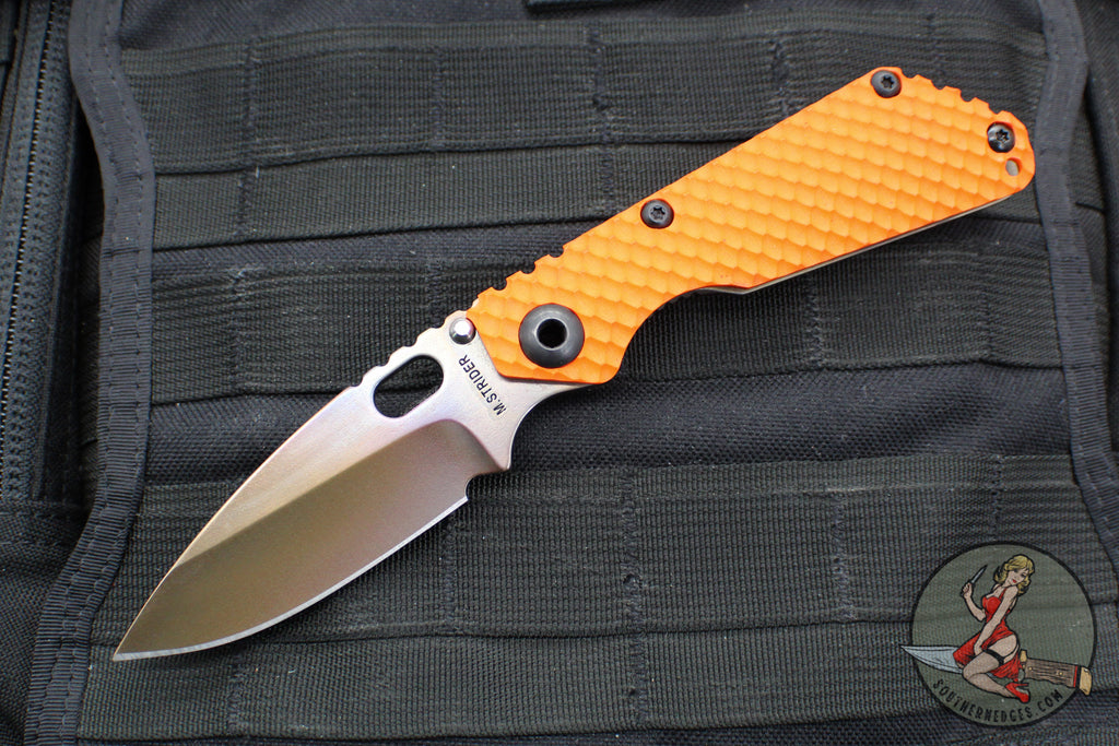 Strider Knives SnG- Drop Point- Special Anodized Titanium Contoured Gunner Grip Scale- Orange G-10 Gunner Grip Scale- Thermal Color Finished Magnacut Blade